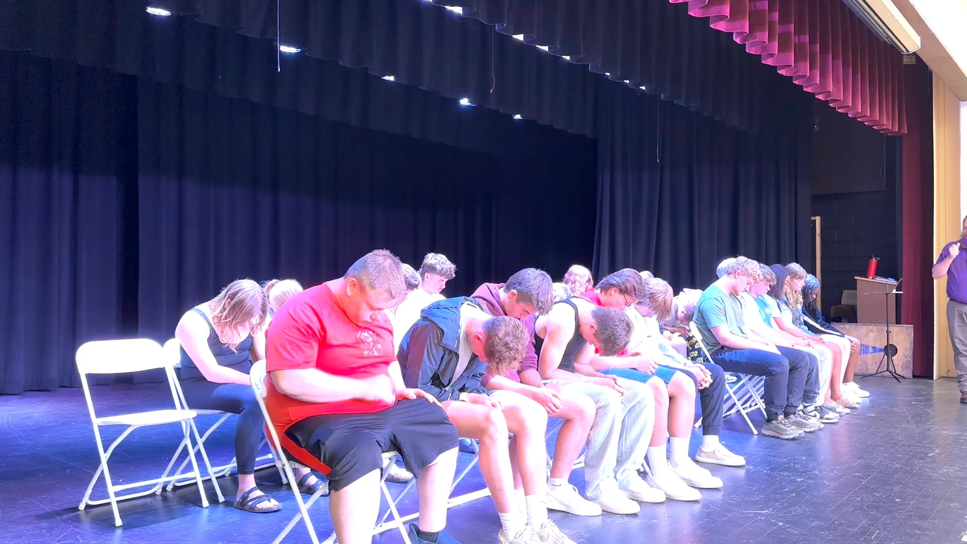 The whole volunteer row heads down mid-induction